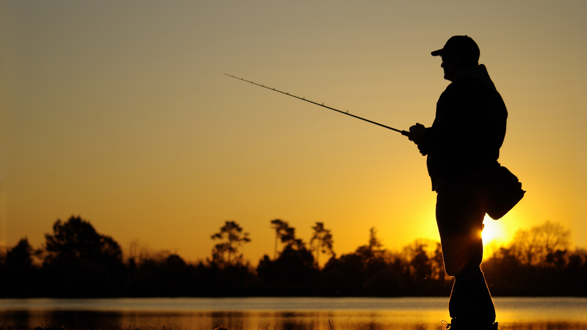 Man fishing during sun set