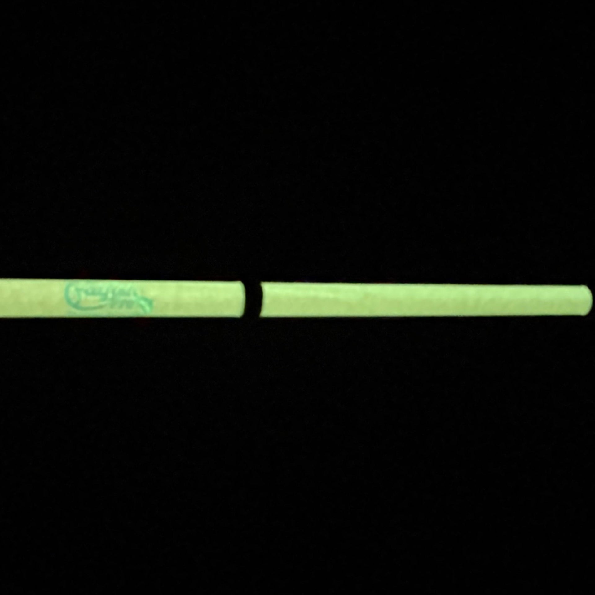Glowing green rectangular object on a black background